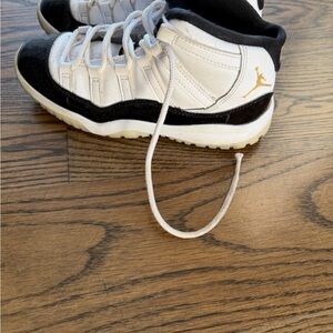 Jordan Kids Black, White, and Gold Sneakers
